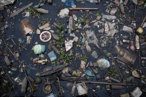 In this Oct. 23, 2013 photo, trash floats on the polluted waters of Guababara Bay in Rio de Janeiro, Brazil. Rio de Janeiro will host the 2016 Olympic Games. Olympic sailors gathered at Guanabara Bay to compete in an event on Saturday, Dec. 7, 2013. Rio's local Olympic organizing committee has promised the pollution will be cleaned up when the Olympics open in 2106, and government officials have pledged to reduce the pollution flowing into the bay. (AP Photo/Felipe Dana)